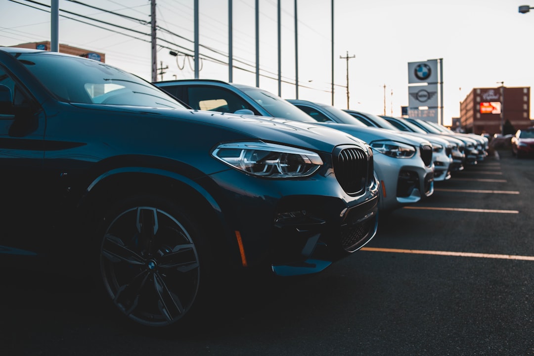 Row of luxury cars in parking lot